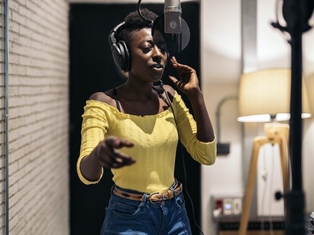 Black Singer Recording in Music Studio